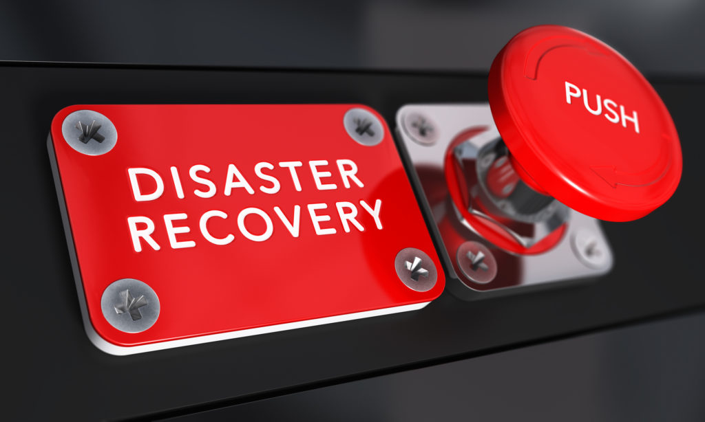 Close up on a red panic button with the text Distaster Recovery with blur effect. Concept image for illustration of DRP, business continuity and crisis communication.
